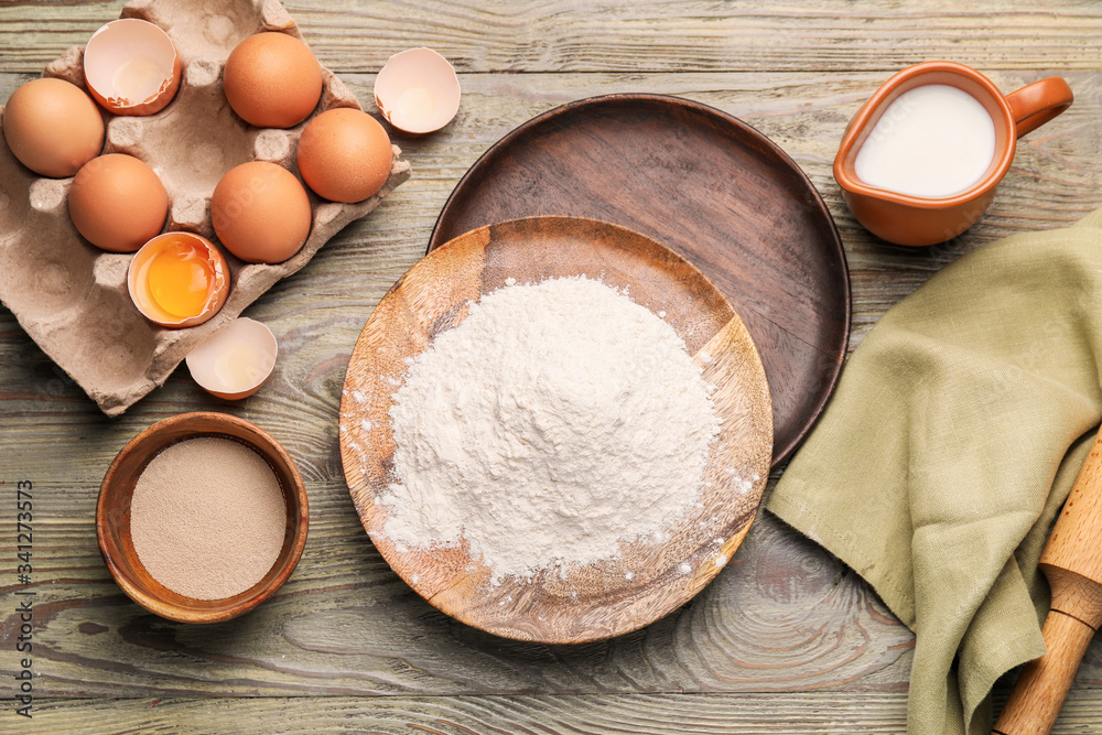 Ingredients for dough on wooden background