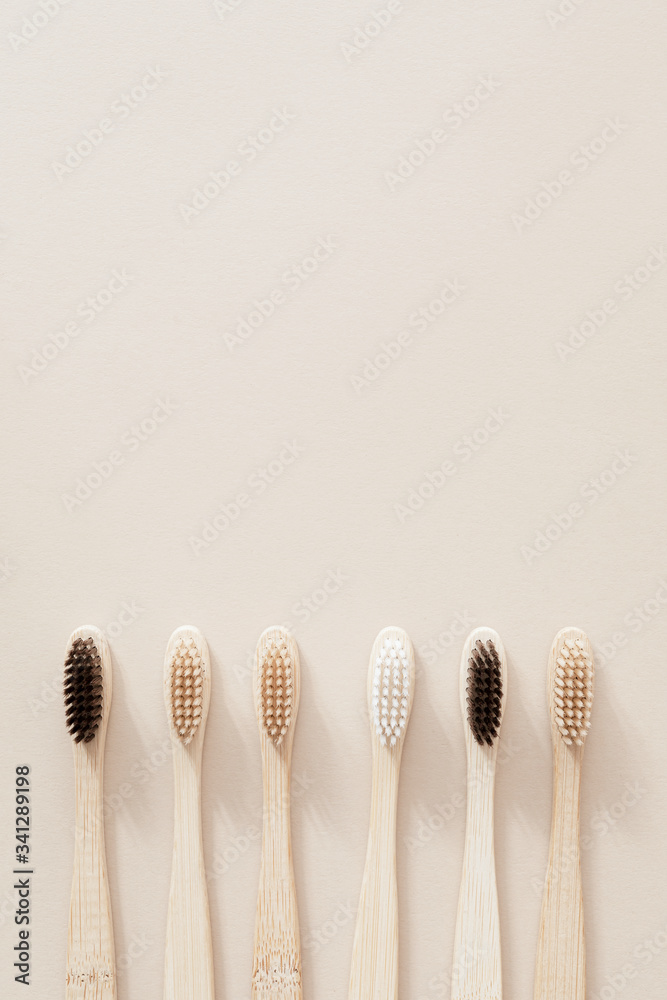 Bamboo toothbrushes on a beige background