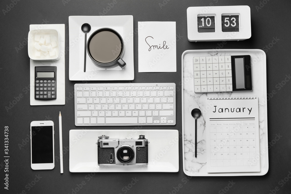 Composition with cup of coffee and different items on black background