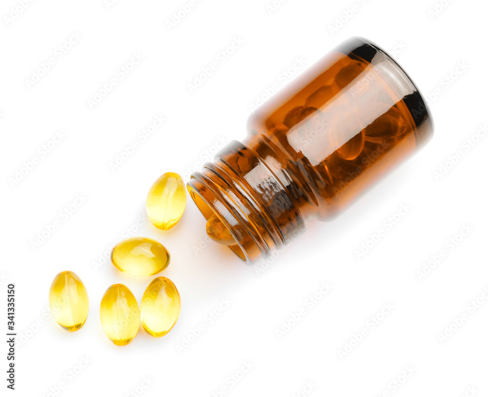 Overturned bottle with fish oil capsules on white background