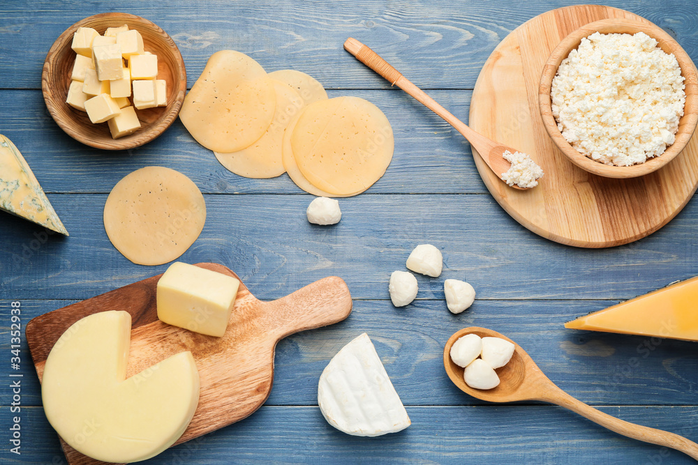 Different dairy products on color wooden background