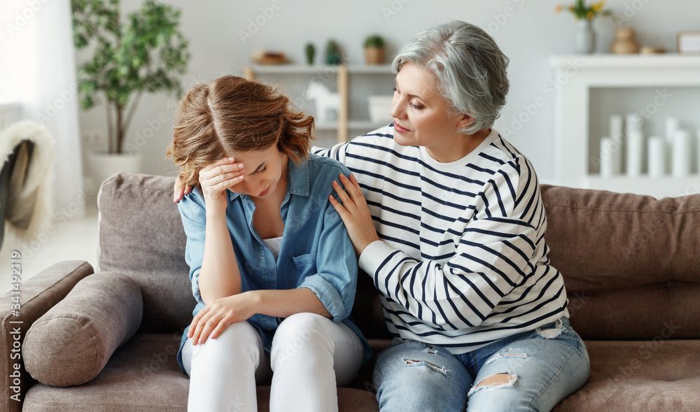 Senior mother comforting crying daughter.