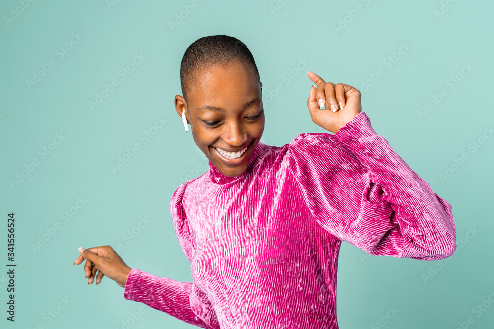 Black woman dancing with wireless earphones