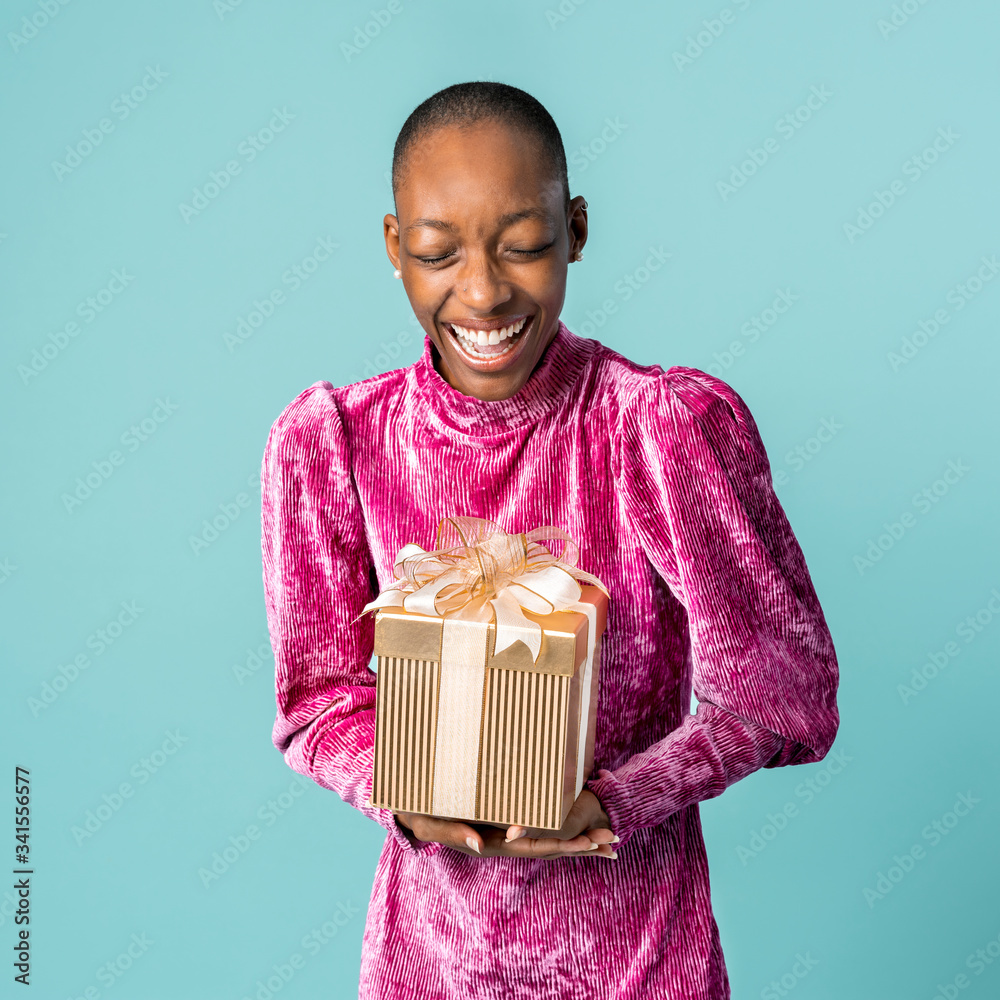 Happy black woman holding a gift box