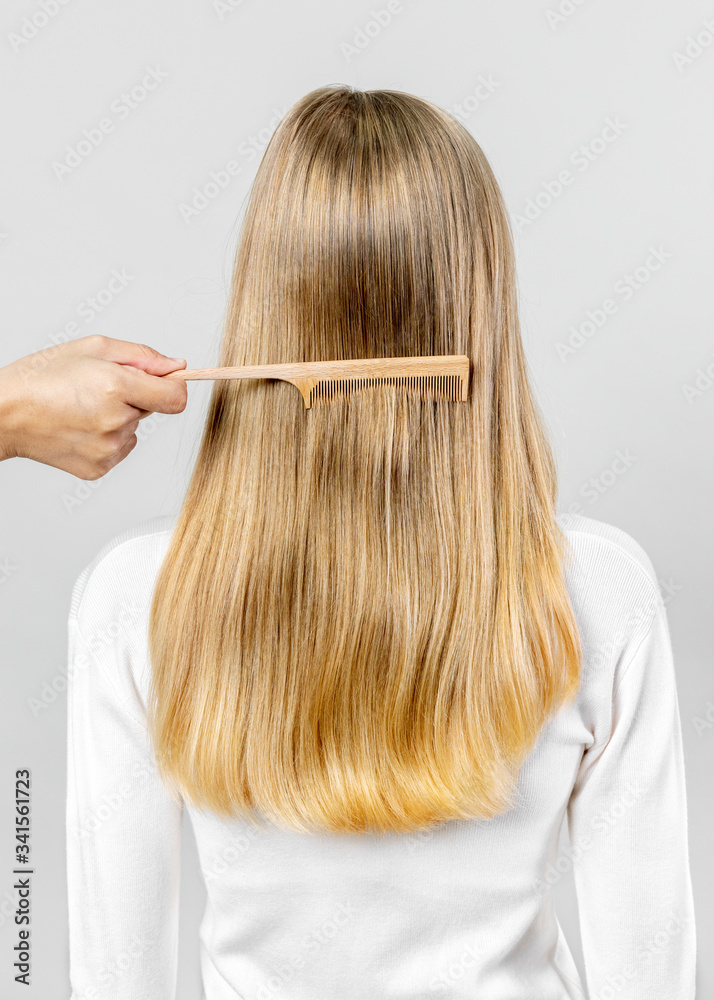 Stylist combing a woman's hair