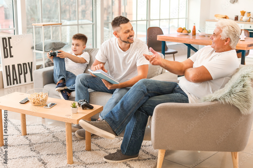 Man with his father and son spending time together at home