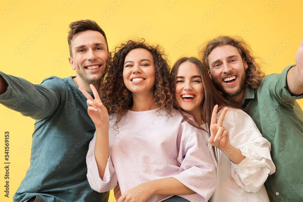 Friends taking selfie on color background