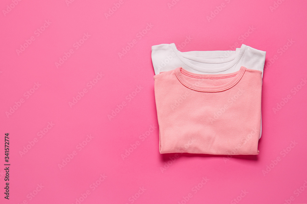 Stylish t-shirts on color background