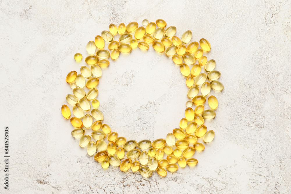 Frame made of fish oil capsules on light background