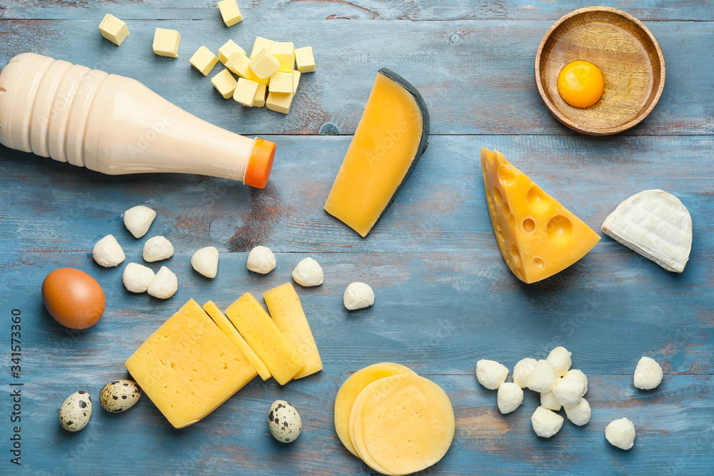 Different dairy products on color wooden background