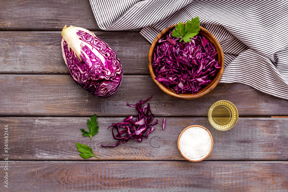 Red cabbage - cut head and sliced - on wooden kitchen table top view