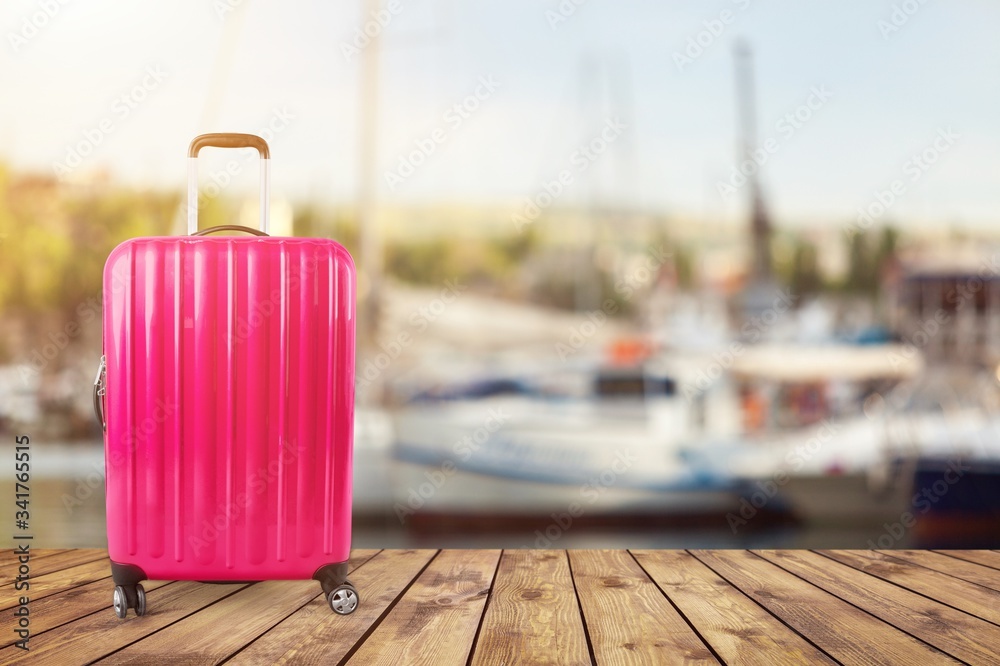 Beautiful colored suitcase on wheels for travel.