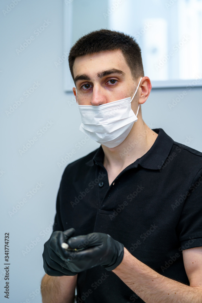 Portrait of a doctor or medical specialist. Vertical portrait. Man in scrubs. White background. Doct