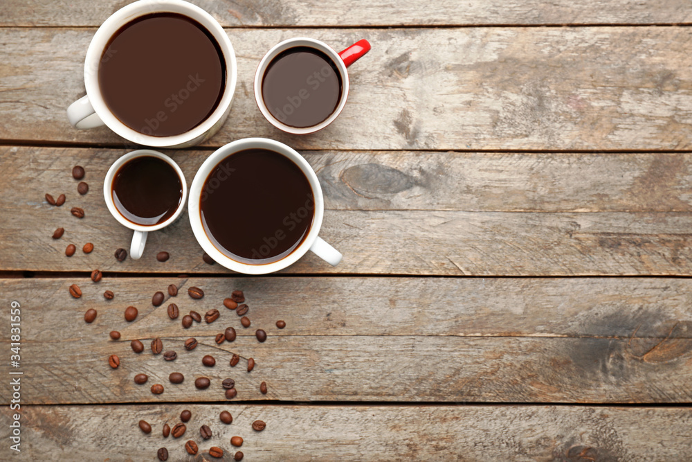 Cups of coffee on wooden background