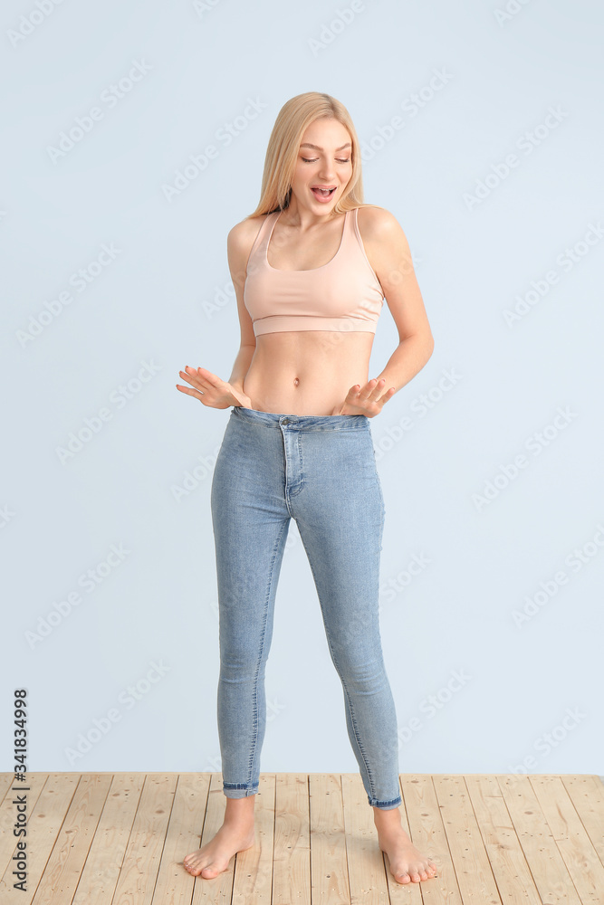 Happy slim woman on color background