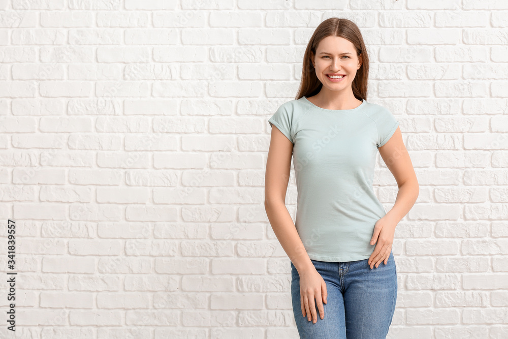 Young woman in stylish t-shirt on white background