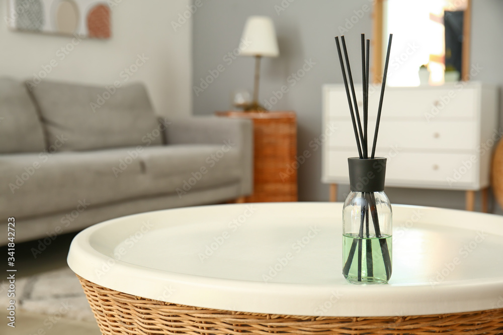 Reed diffuser on table in room