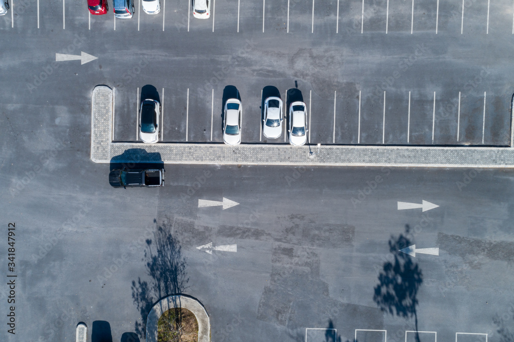 Aerial view drone shot of parking lot outdoors vehicles in the park