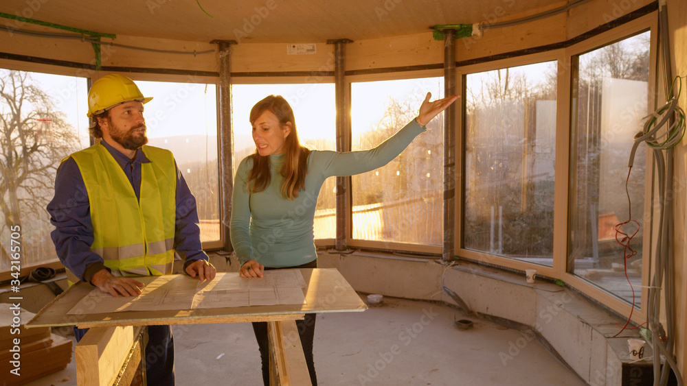 CLOSE UP: Furious woman reprimands engineer for not working according to plans.