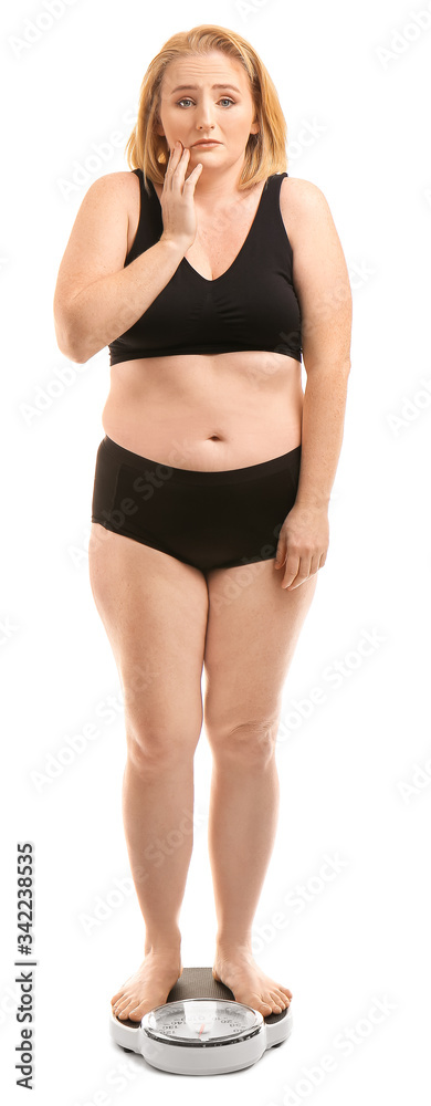 Sad overweight woman with scales on white background. Weight loss concept