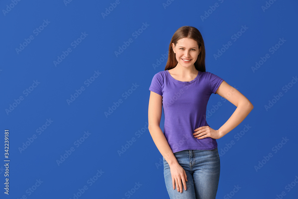 Young woman in stylish t-shirt on color background