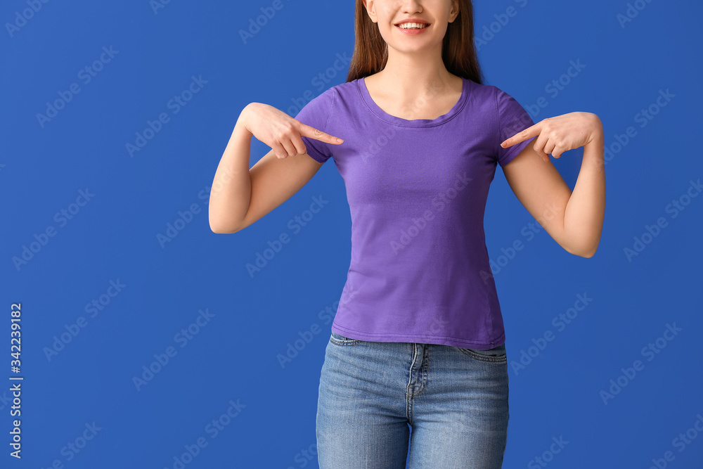 Young woman in stylish t-shirt on color background