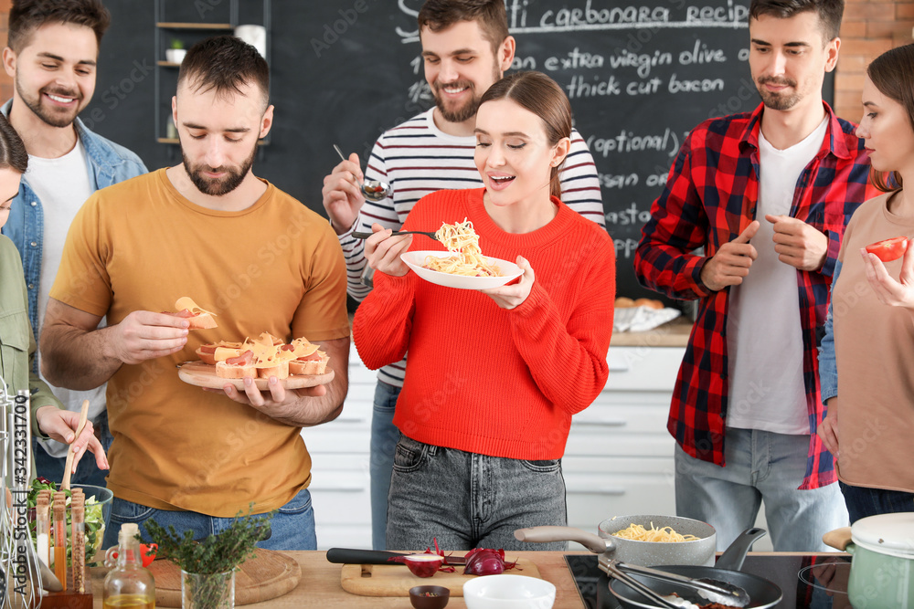 Young friends cooking together at home