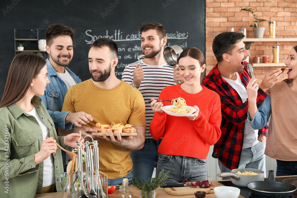 Young friends cooking together at home