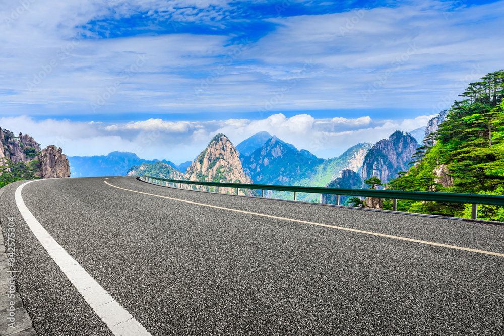 Empty asphalt road and green mountain with beautiful clouds landscape.