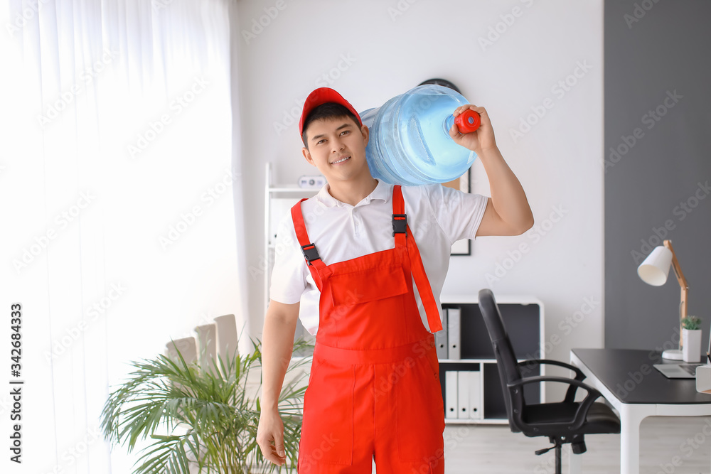 Delivery man with bottle of water in office