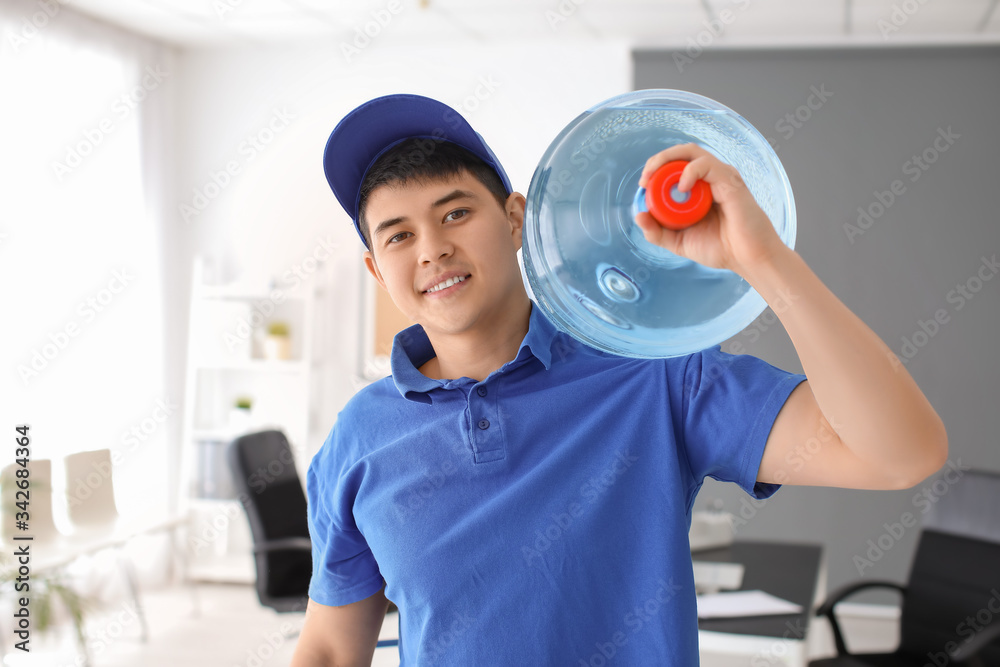 Delivery man with bottle of water in office