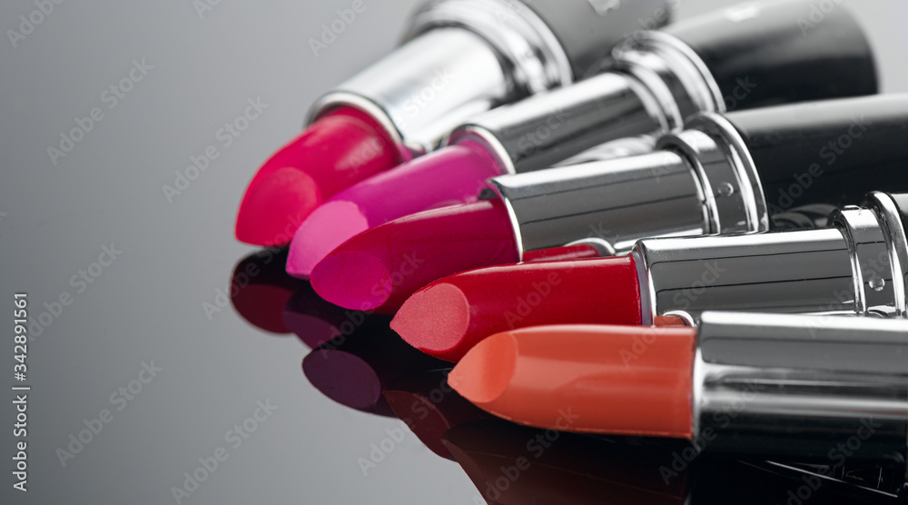 Lipstick. Fashion Colorful Lipsticks over black background. Lipstick tints palette, Professional Mak