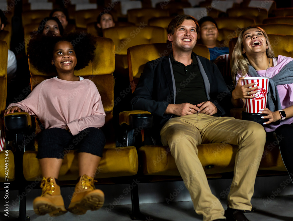 People audience watching movie in the movie theater cinema. Group recreation activity and entertainm