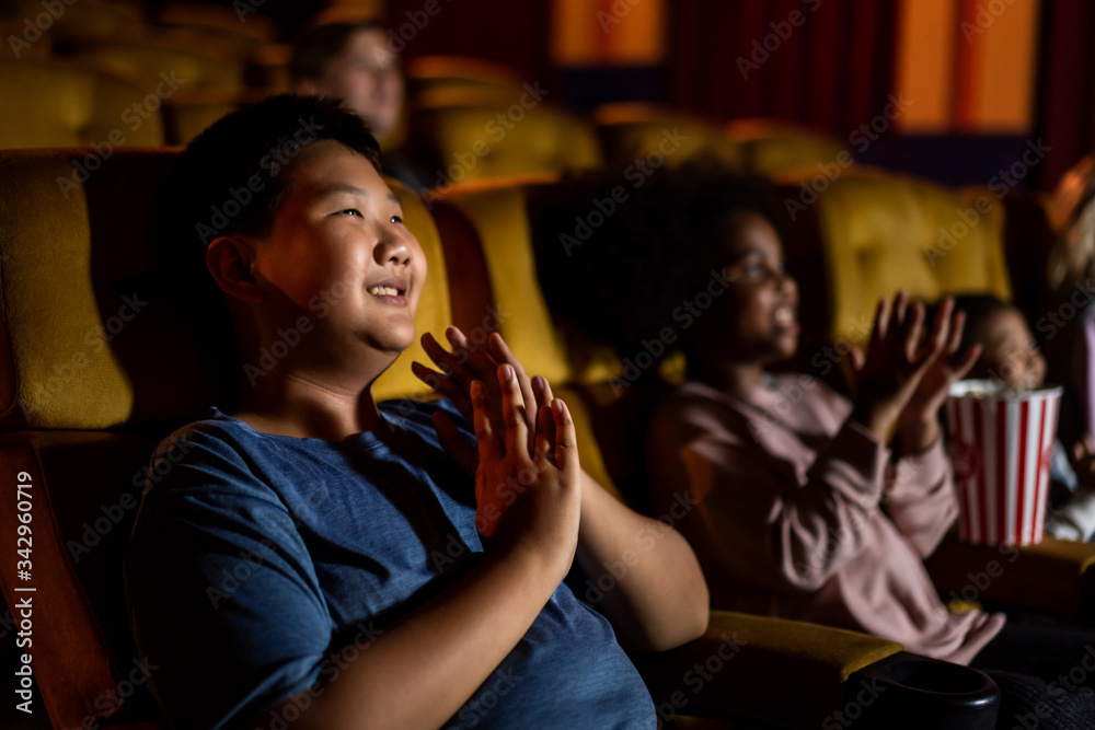 People audience watching movie in the movie theater cinema. Group recreation activity and entertainm