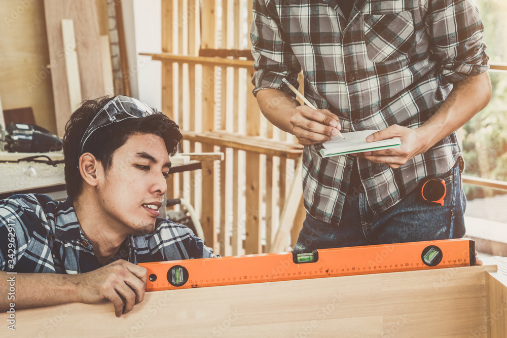 Carpenter working on wood craft at workshop to produce construction material or wooden furniture. Th