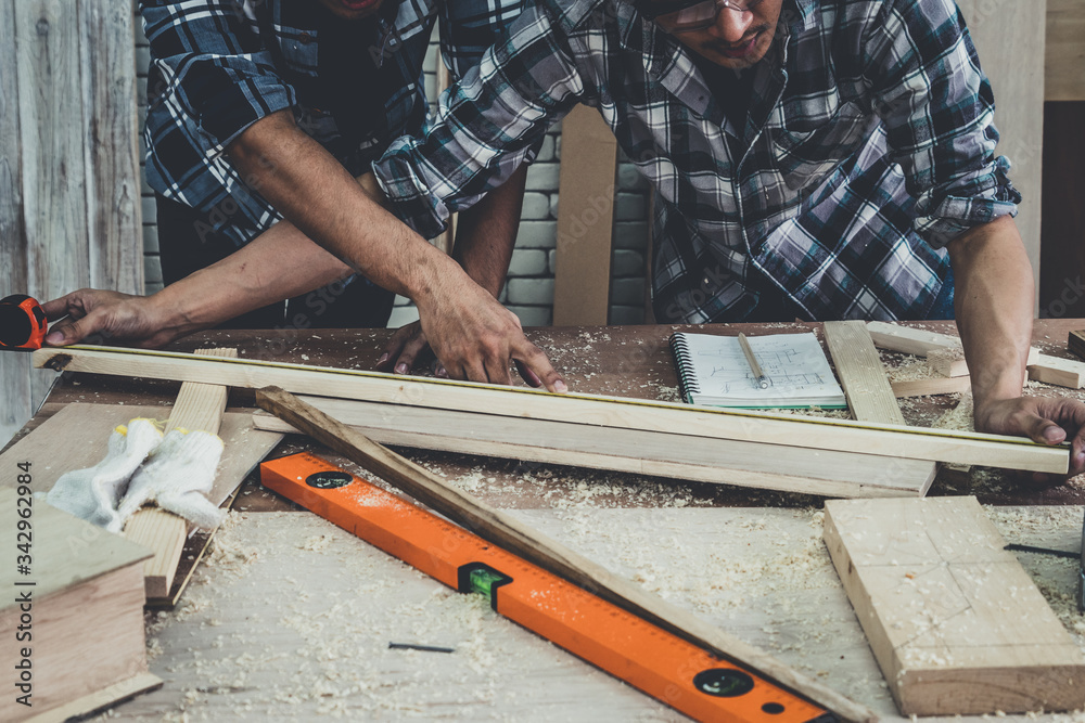 Carpenter working on wood craft at workshop to produce construction material or wooden furniture. Th