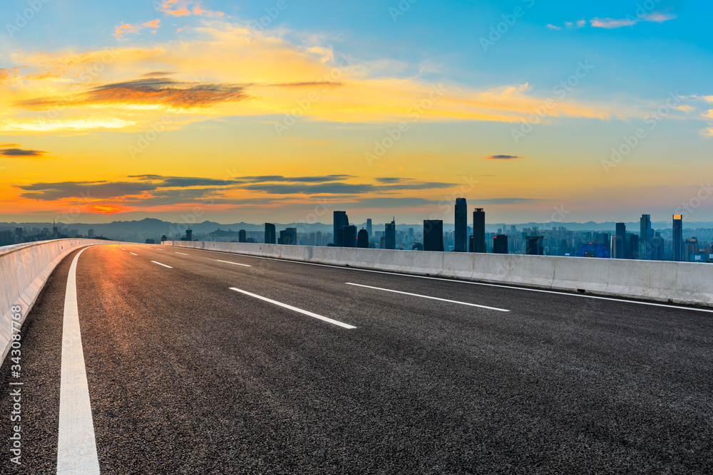 Empty asphalt road and Chongqing city skyline and buildings at sunset,China.