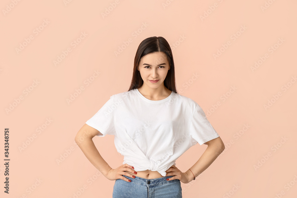 Portrait of beautiful young woman on color background