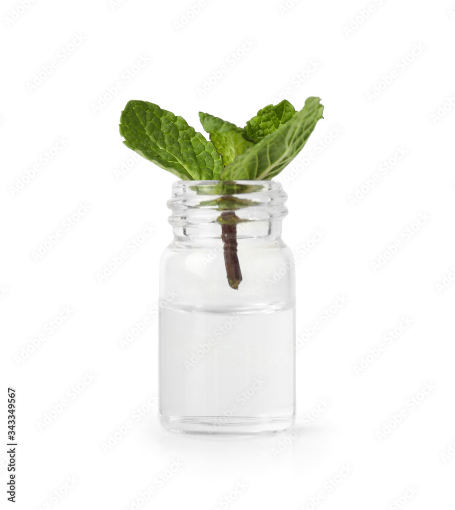 Bottle with mint essential oil on white background