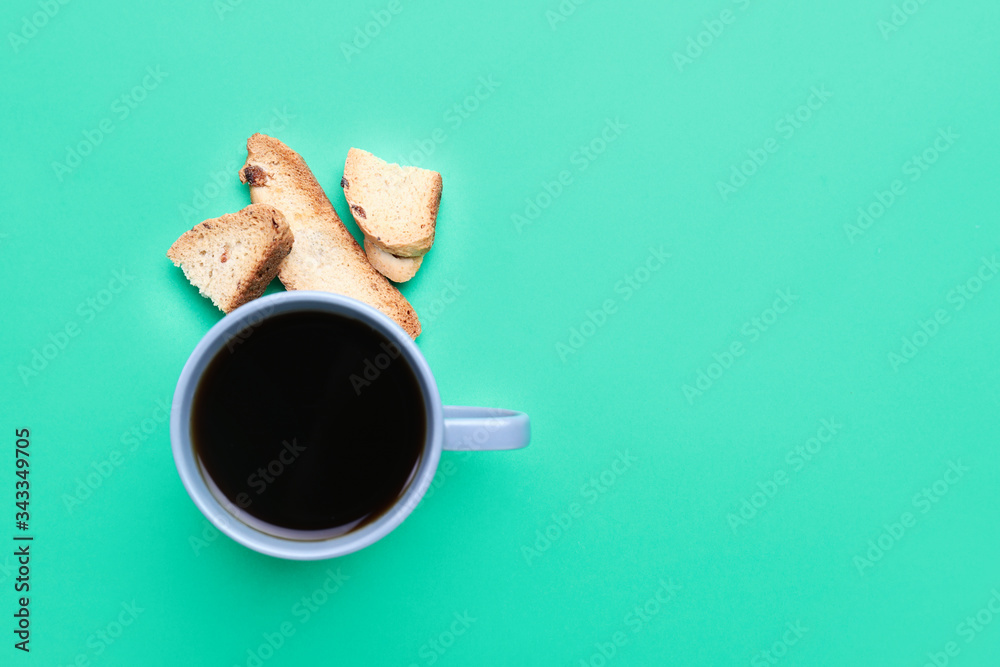 Cup of coffee with cookies on color background