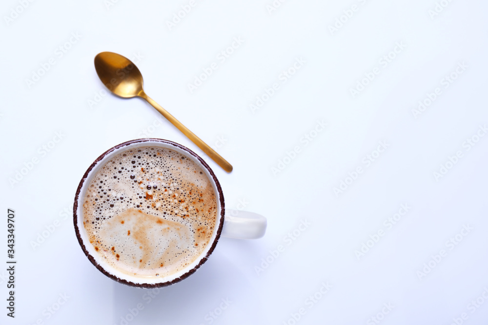 Cup of coffee with spoon on white background