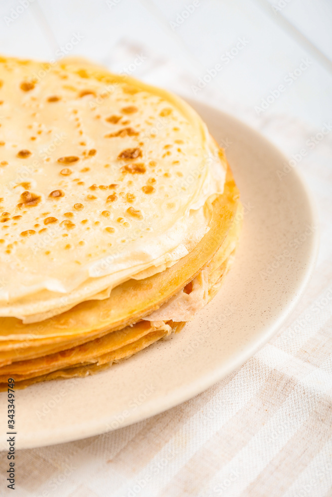 Plate with tasty blini on table, closeup