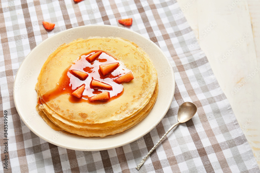 Tasty blini with berries on table