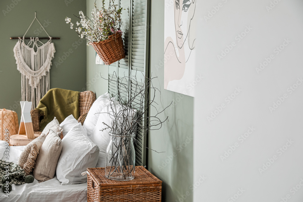 Interior of beautiful modern bedroom with spring flowers