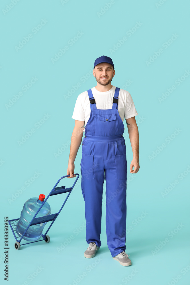 Delivery man with bottle of water on color background