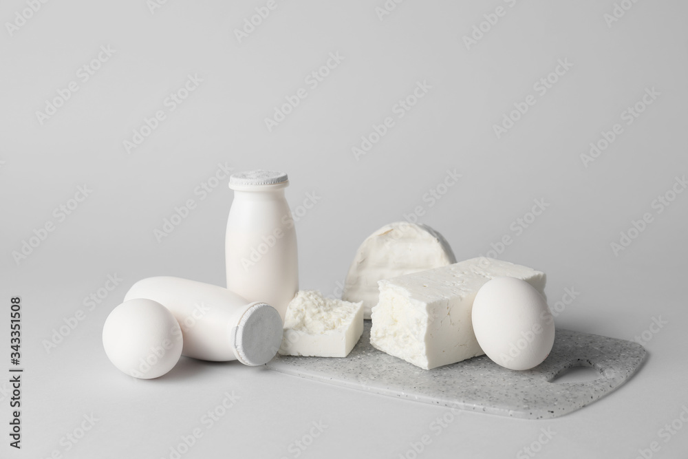 Different dairy products without lactose on grey background