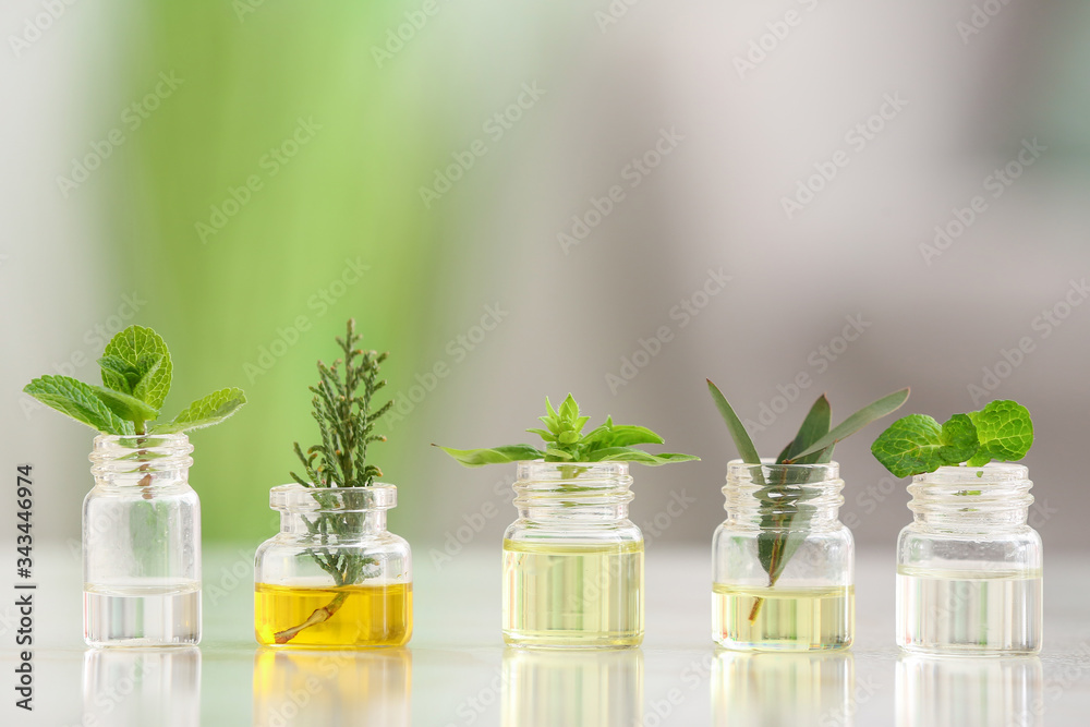 Bottles with different essential oils on table