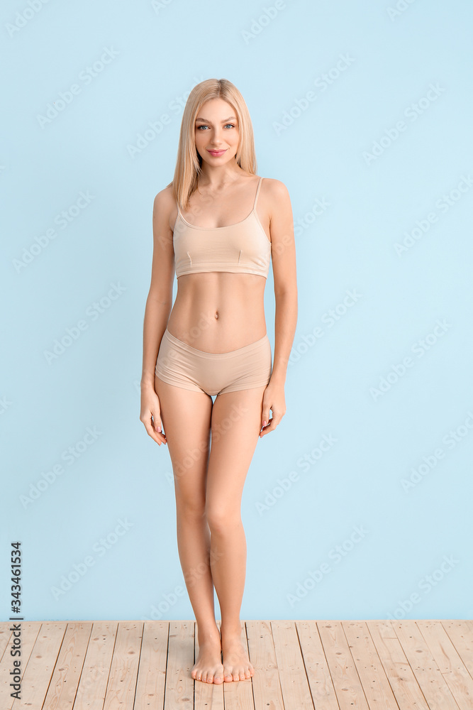 Slim woman on color background