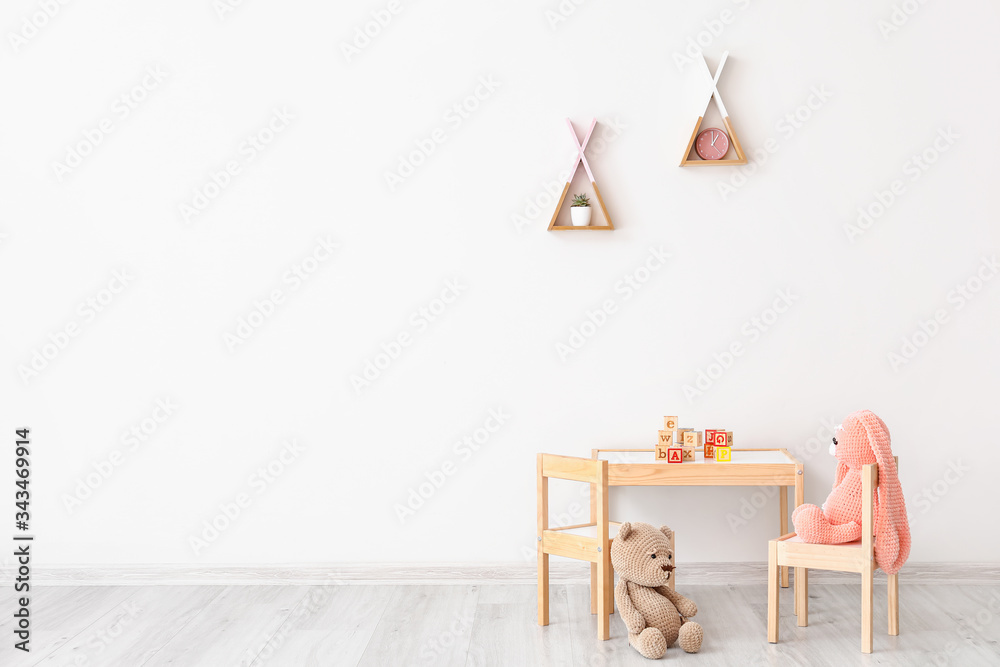 Table with chairs and toys in childrens room