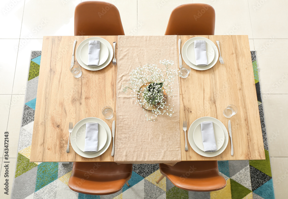 Served table in modern dining room, top view